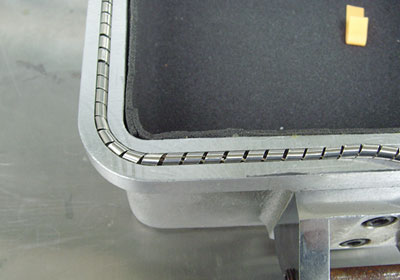 Electromagnetic shielding spiral gasket with groove mount on the opening and closing of the enclosure